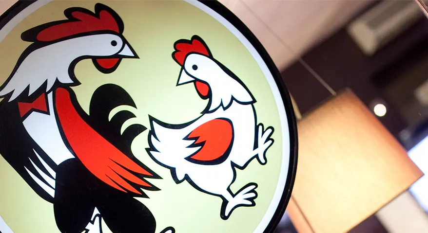 The rooster and hen logo on a Max's Restaurant sign